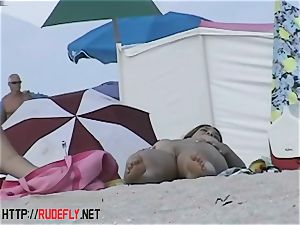 Beach cuties hang out naked below the sun